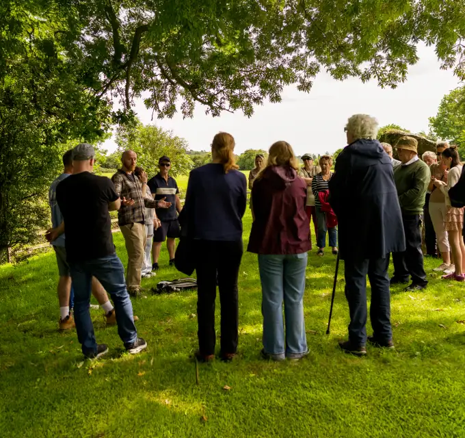 Group of visitors taking a guided tour at Lough Gur